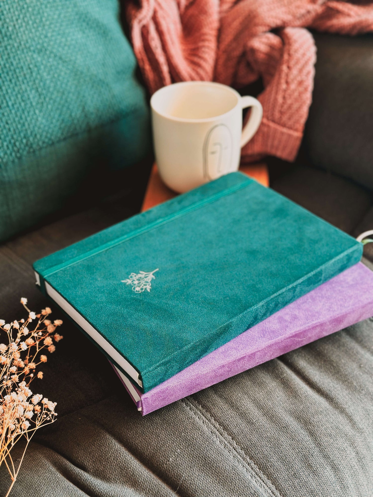 Green and purple journal with velvet journals on couch