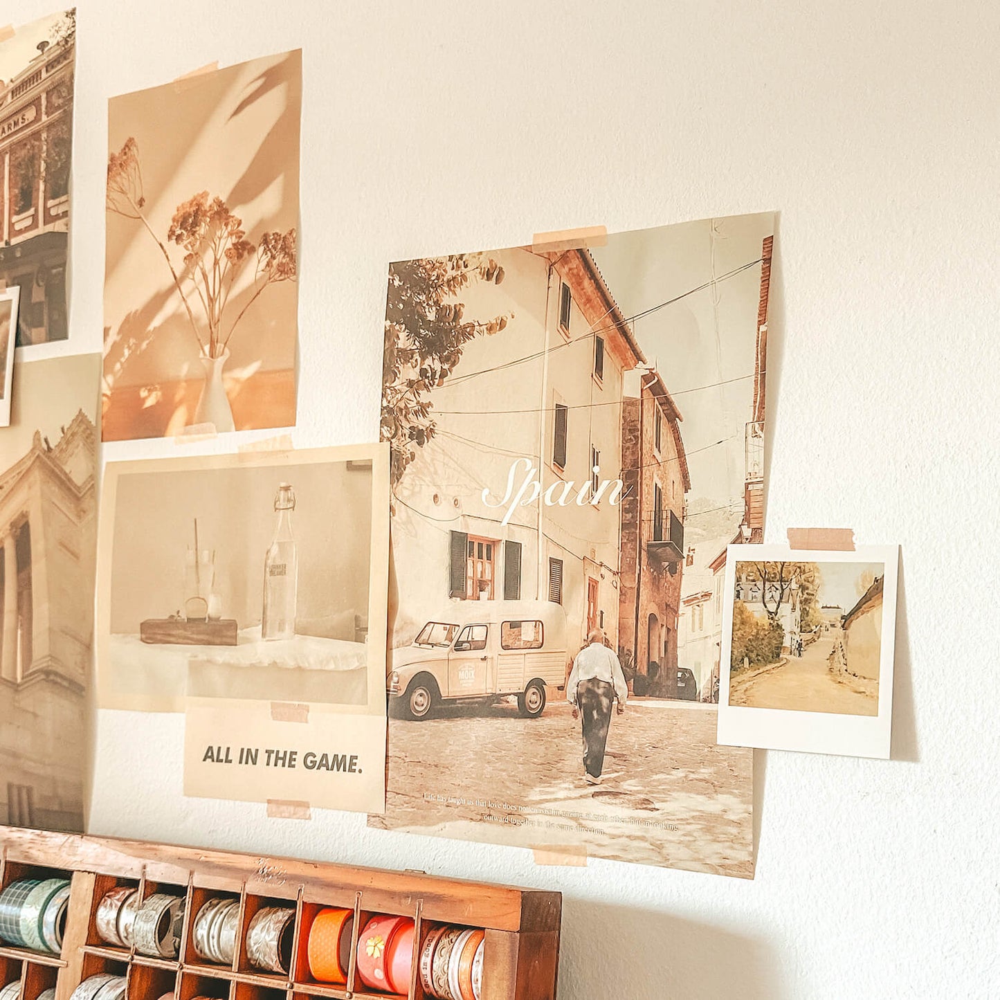 Posters on wall with photo of spain and interior space
