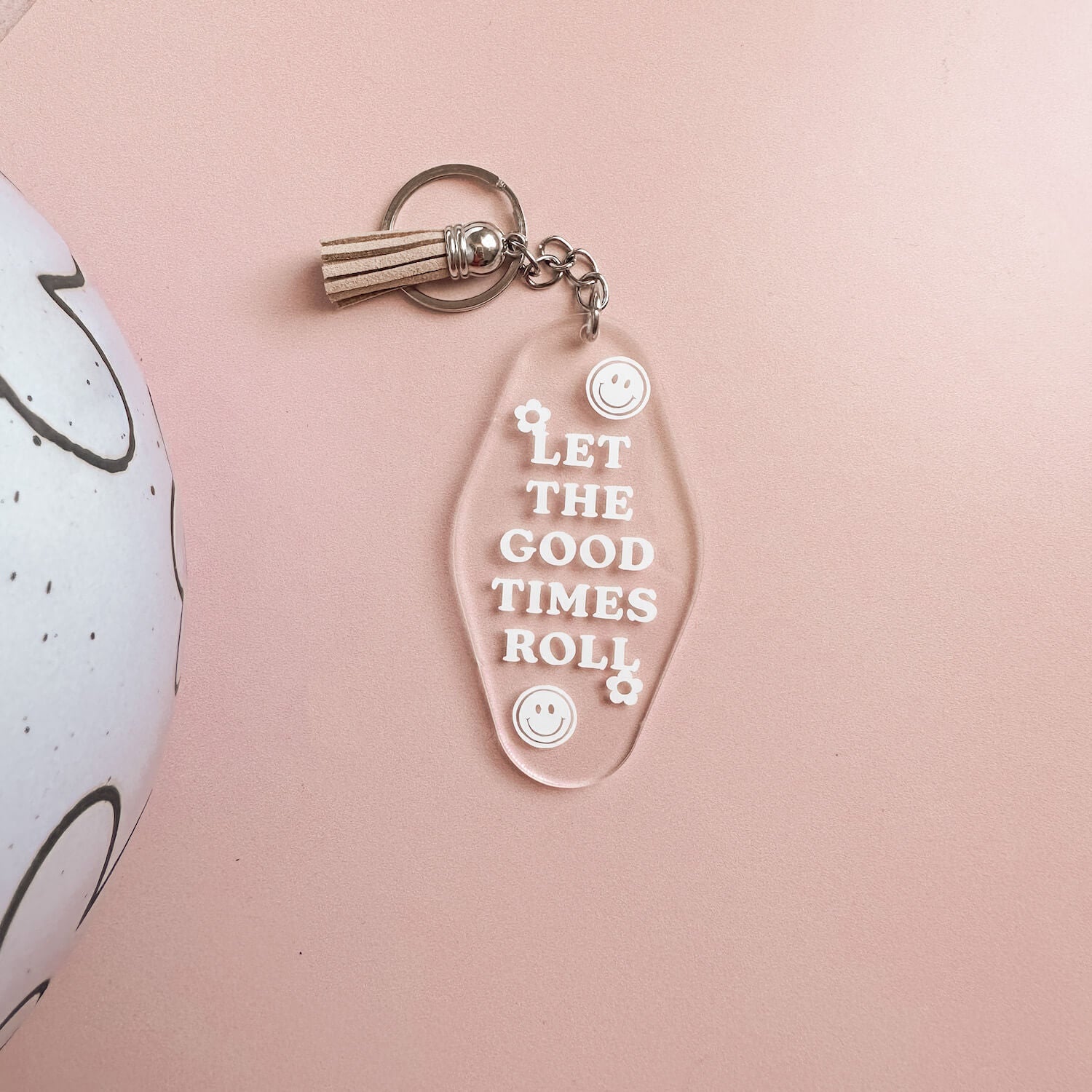 Acrylic keyring with text 'let the good times roll' including brown tassle