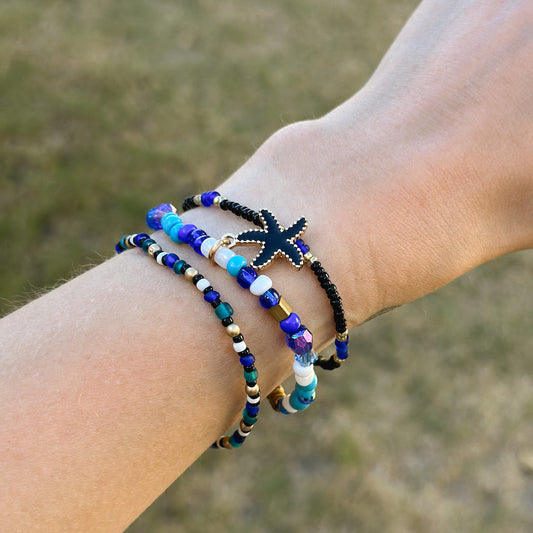 Set of 3 blue beaded bracelets with black metal starfish charm