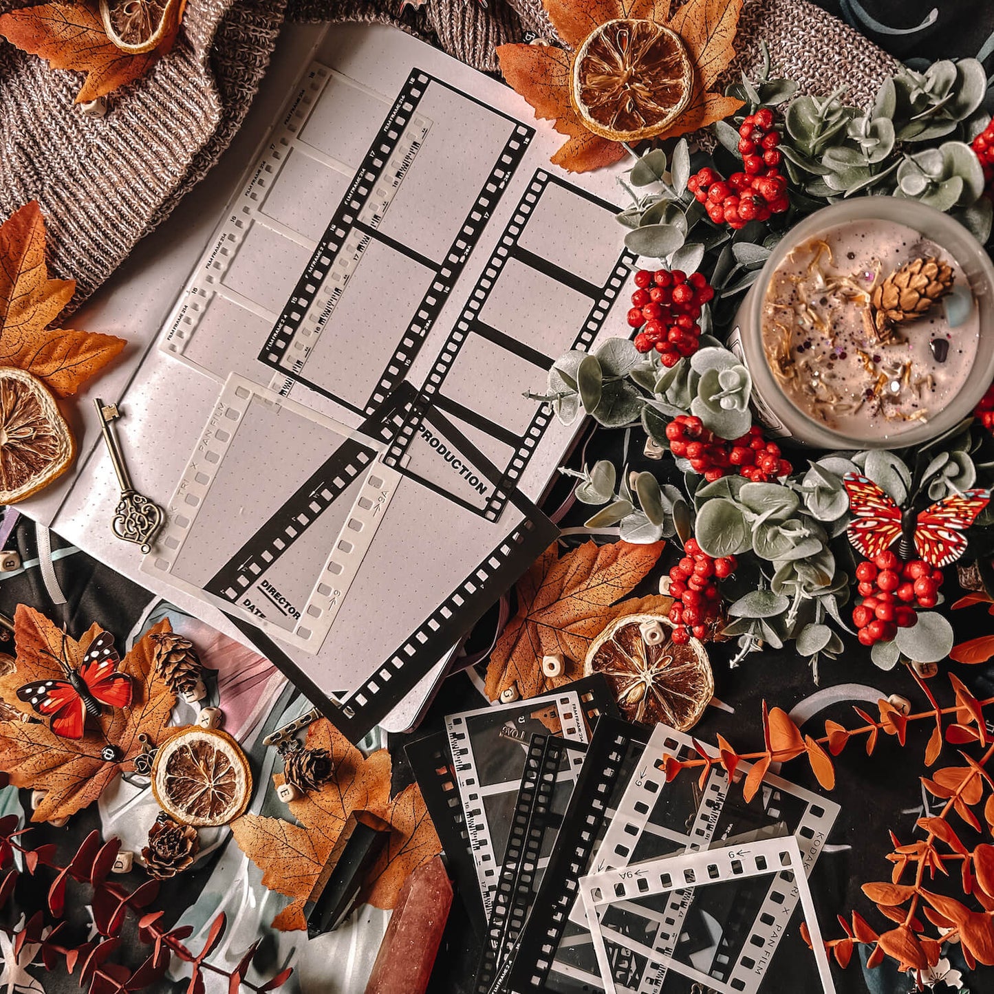 Black and white PET film stickers on a table filled with autumn leaves and a sweater