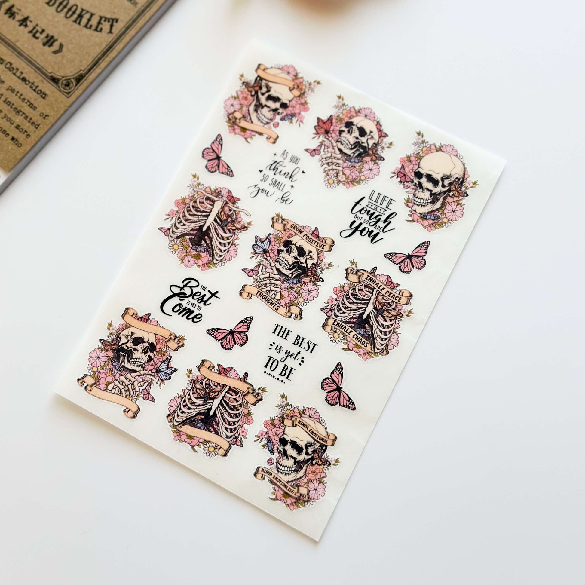 Vinyl sticker sheet with pink butterflies and skulls illustrations