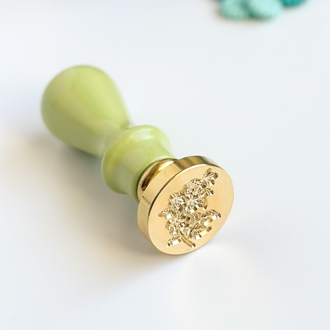 25mm Brass wax seal stamp with flower design has green, wooden handle. 